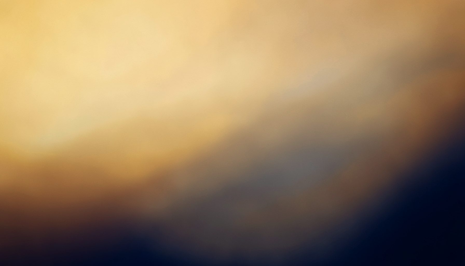 Warm-toned abstract background with soft golden and deep navy gradients suggesting financial stability and home ownership